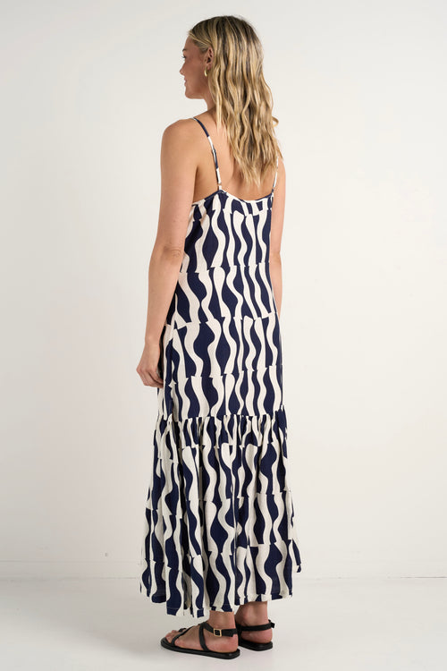 model wears a black and navy stripe maxi dress