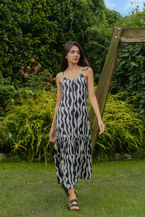 model wears a black and navy stripe maxi dress