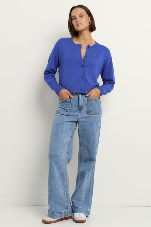 model wears a blue cardigan with light blue jeans