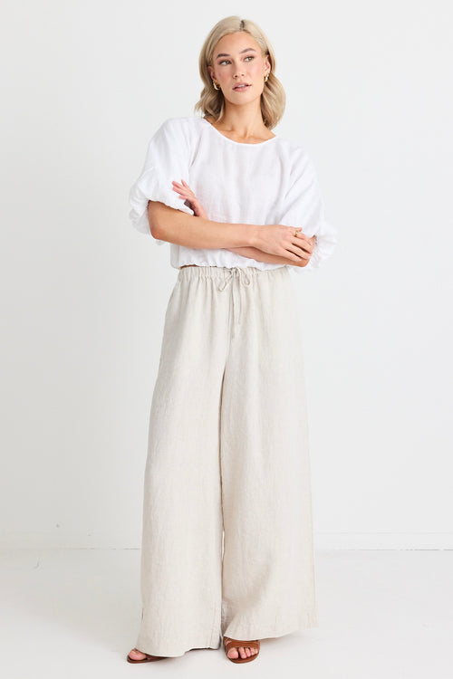 model wears a beige wide leg linen pant