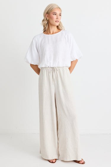 model wears a beige wide leg linen pant