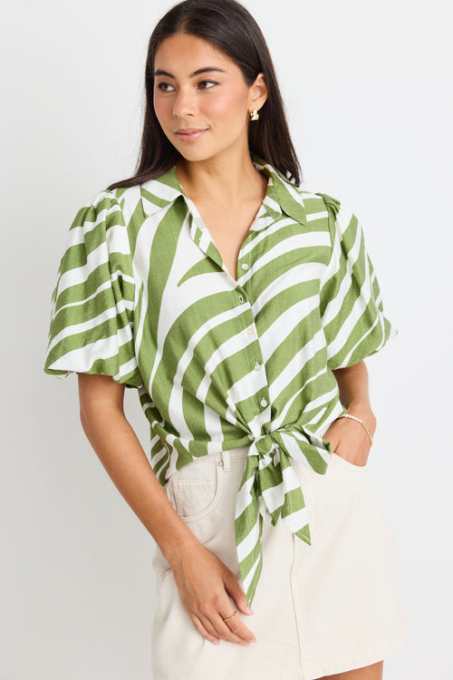 model wears a green and white stripe shirt