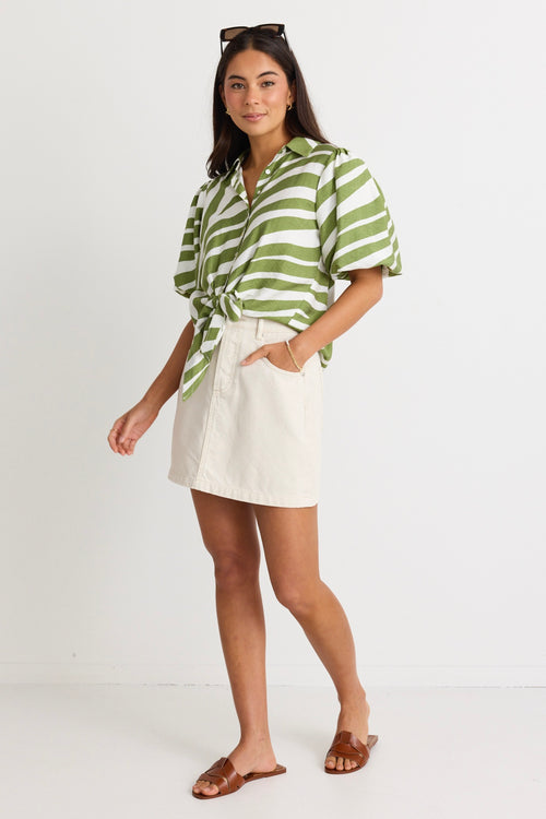 model wears a green and white stripe shirt