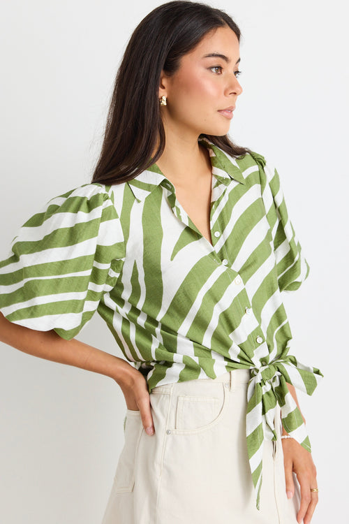 model wears a green and white stripe shirt