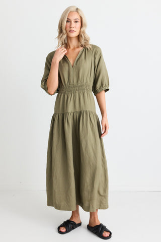 model wears light green maxi dress and black sandals