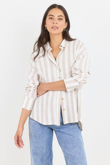 Woman wearing a striped shirt and jeans on a white background