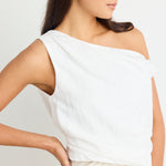 model wears linen one shoulder white top