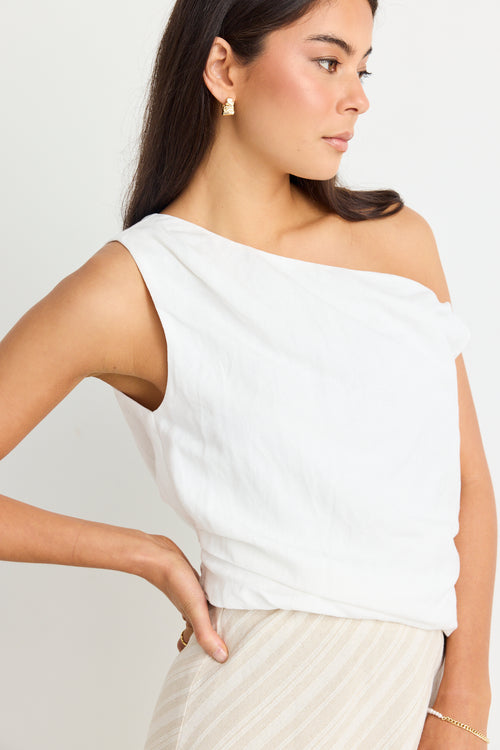 model wears linen one shoulder white top