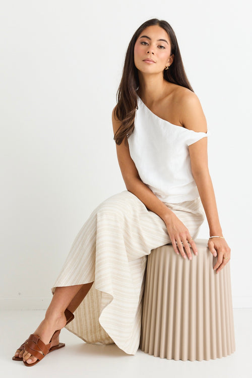 model wears a white linen one shoulder top