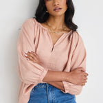 model wears a pink linen top 