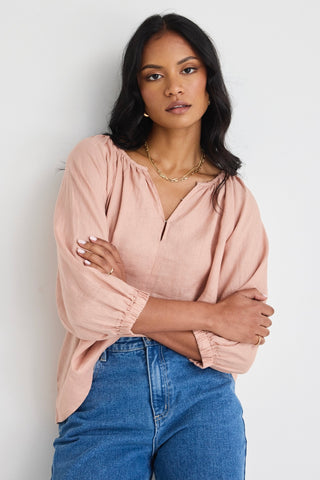 model wears a pink linen top 