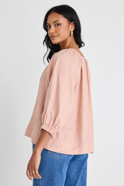 model wears a pink linen top 