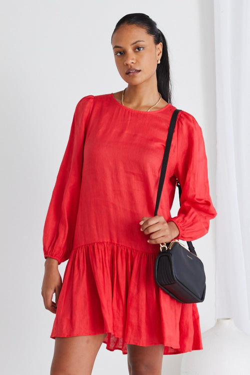 model wears a red long sleeve dress