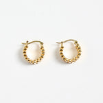 gold-plated brass hoop earrings with a ridged texture, photographed flat against a white background.