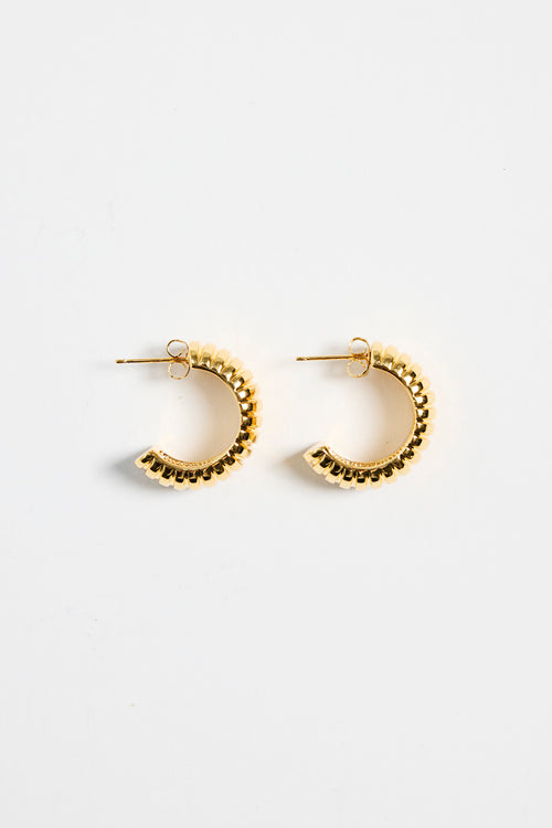gold-plated brass huggie earrings with a ridged design, photographed flat on a white background.