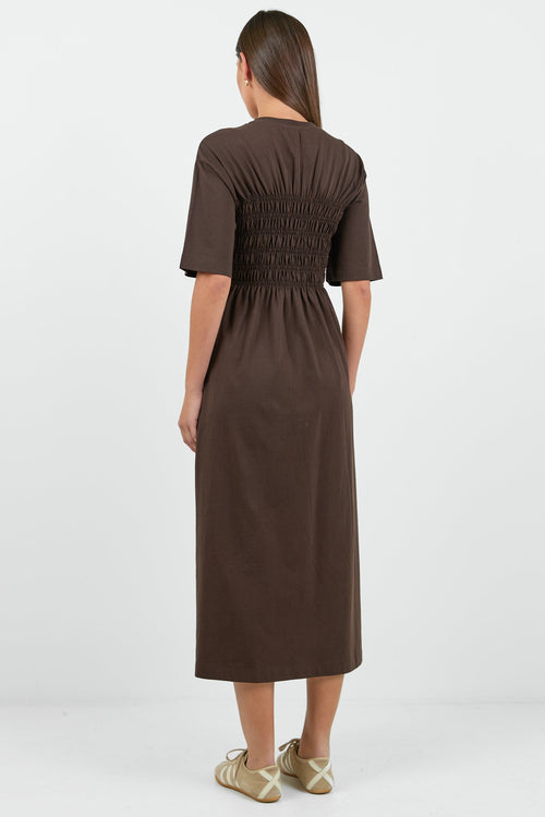 Woman wearing a brown dress on a white background