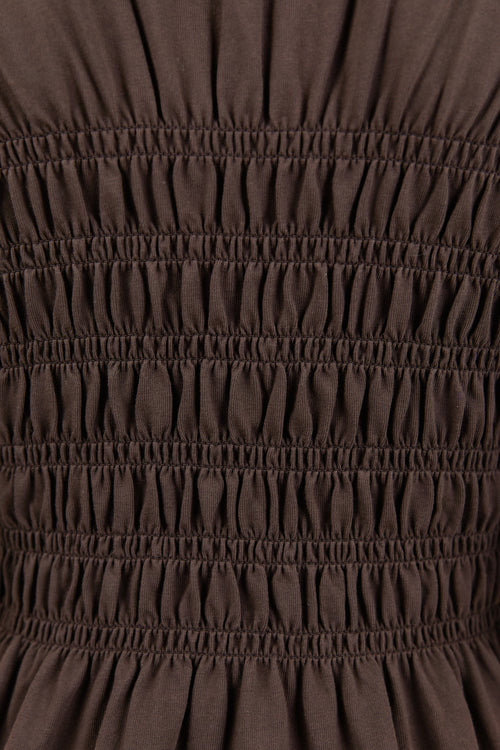 Close-up of brown fabric with gathered texture
