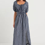 Woman wearing a blue checkered dress on a white background