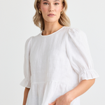 model wears white linen top