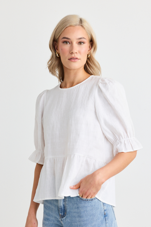 model wears white linen top