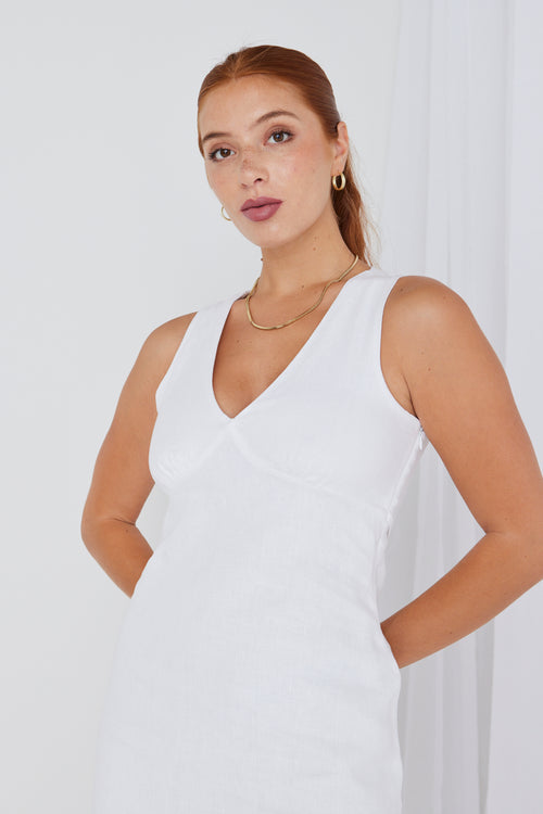 model wears a white linen mini dress