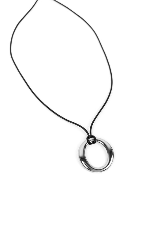 A minimalist silver-toned metal ring pendant on a thin black cord necklace, shown against a plain white background.