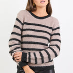 Woman wearing a striped sweater against a white background