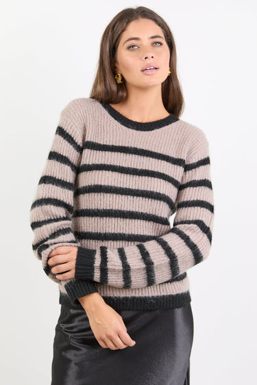 Woman wearing a striped sweater against a white background
