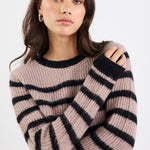 Woman wearing a striped sweater against a white background