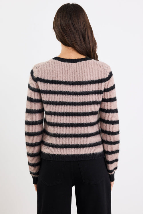Person wearing a striped sweater with black and beige colors on a white background