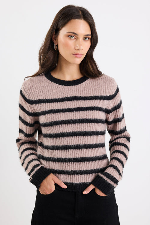 Woman wearing a striped sweater on a white background