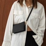 Woman wearing black saben bag