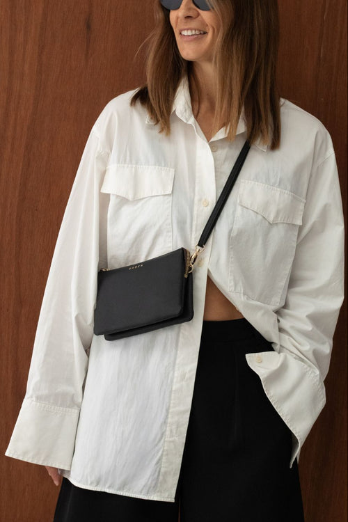 Woman wearing black saben bag