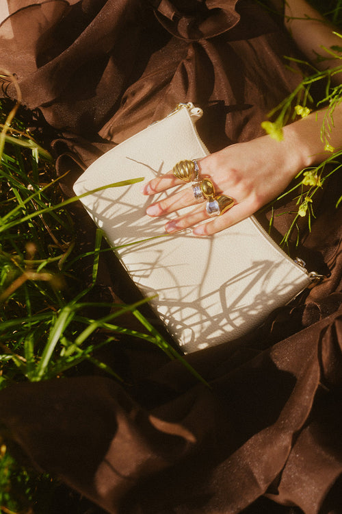 Person holding a book with rings on a grassy background