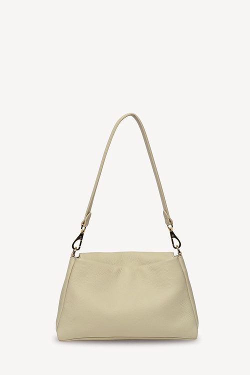 A light beige leather shoulder bag with a matching adjustable shoulder strap and gold-tone hardware, shown against a plain off-white background.