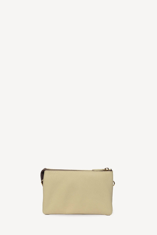 A minimalist rectangular zip pouch in light beige leather with gold-tone hardware, shown against a solid off-white background.