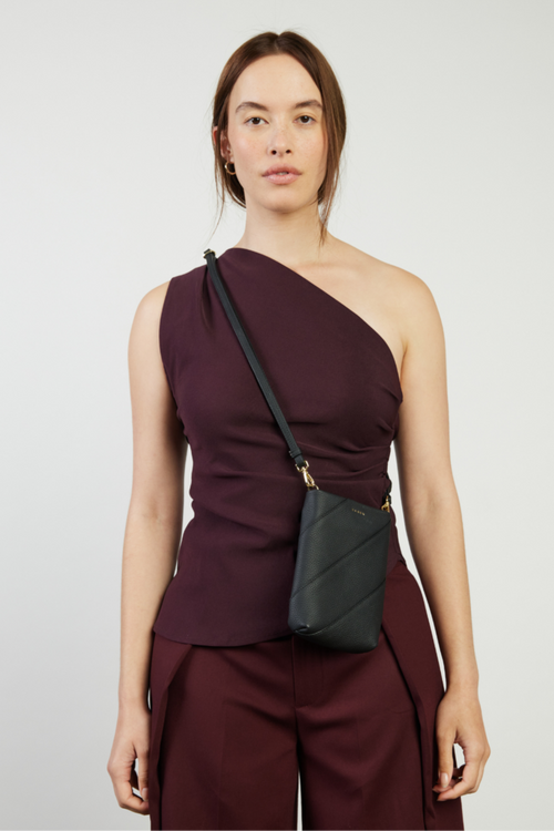 model holding black bag