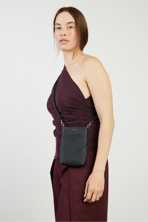 model holding black bag