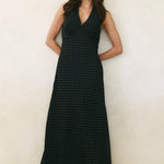 Model wearing black ditsy polka dot maxi dress