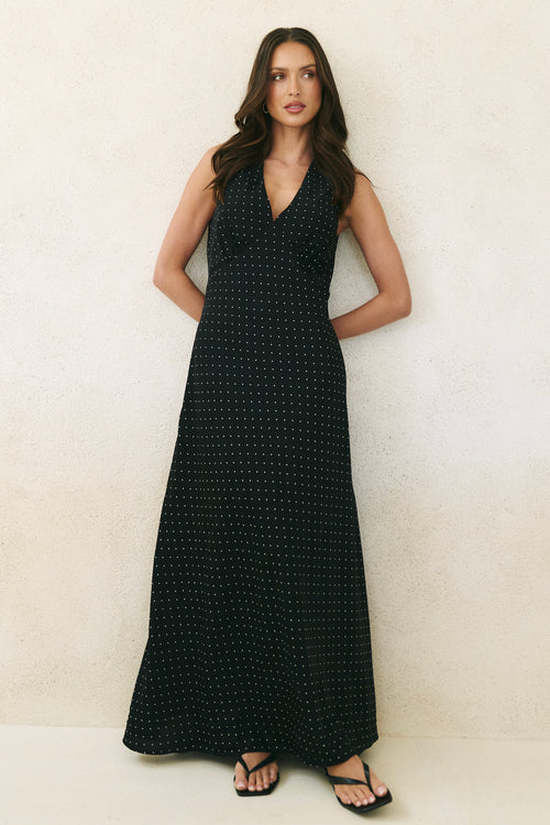 Model wearing black ditsy polka dot maxi dress