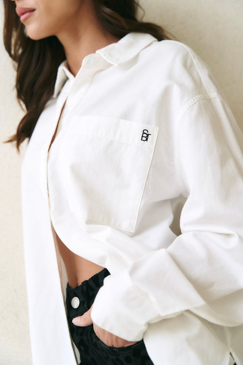 model wearing white button up shirt 