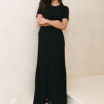 Model wearing a black knit dress