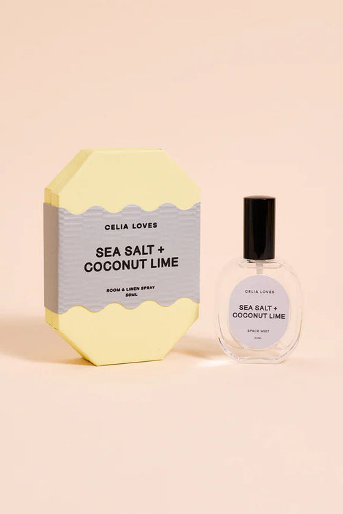 Sea Salt + Coconut Lime room and linen spray with packaging on a beige background