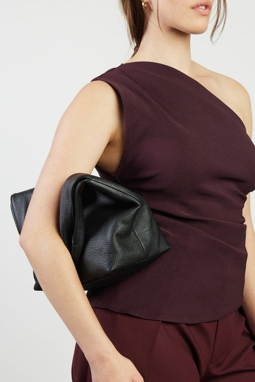 model holding black bag
