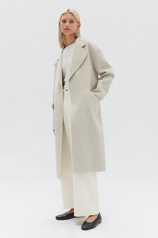 model wears a white coat