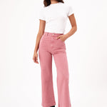 model wears pink jeans with a white tee shirt