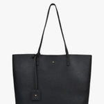 A black pebbled leather tote bag with dual shoulder straps, a hanging leather tag, and a small gold logo emblem on the front, shown against a plain white background.