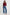 Woman wearing a burgundy sweater and blue jeans on a white background