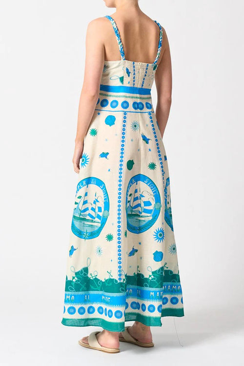 Woman wears a colourful blue strappy maxi dress