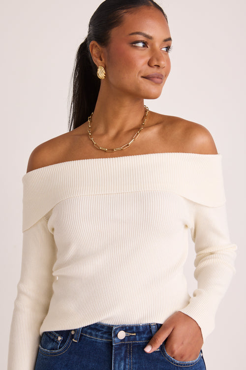 model wears a white off the shoulder top